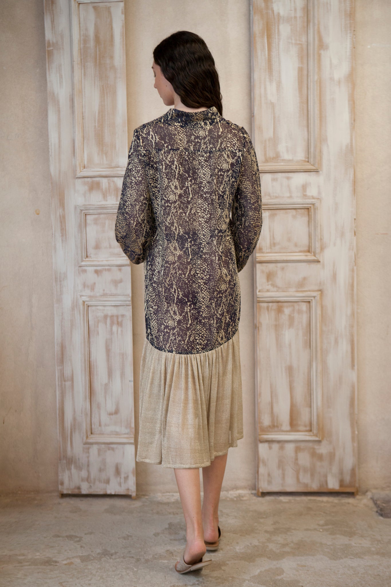 Relaxed fit, long sleeve gold-blue midi dress. The gold frill trim adds a touch of playful charm