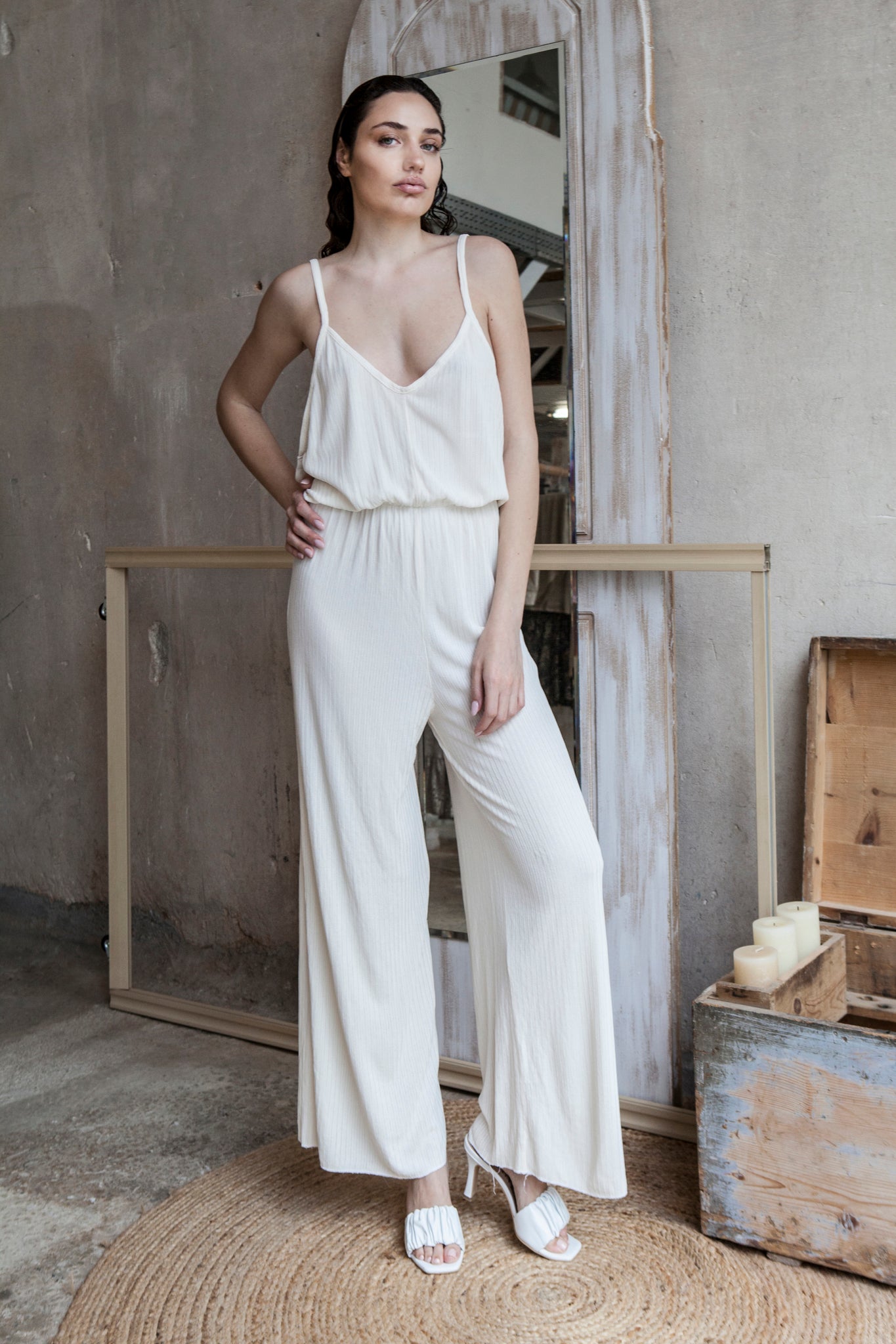Long-length white backless jumpsuit, offering a loose and relaxed fit.