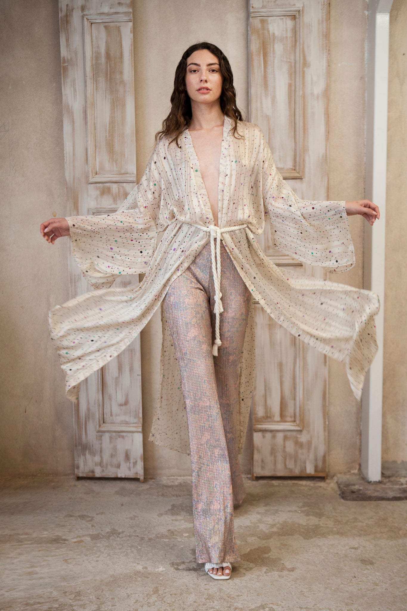 Long-sleeved kimono, featuring a cream hue adorned with playful colored spots and sparkling gold lines