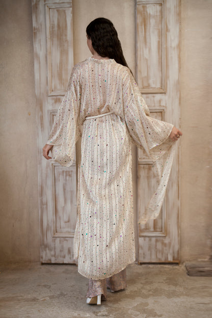 Long-sleeved kimono, featuring a cream hue adorned with playful colored spots and sparkling gold lines