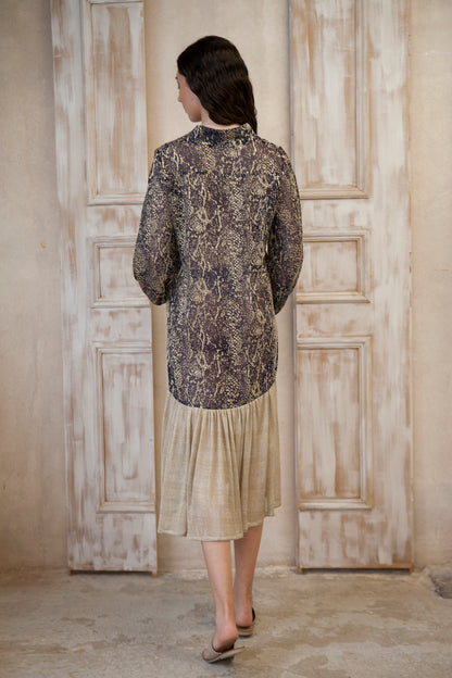 Relaxed fit, long sleeve gold-blue midi dress. The gold frill trim adds a touch of playful charm