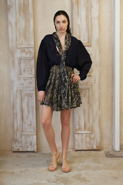 Blue mini dress features a full gold details finish, plus a trendy bow tie.