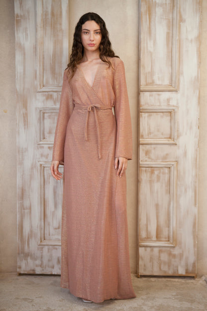 Long-sleeved, maxi-length wrap designed dress. Crafted from glinting fabric